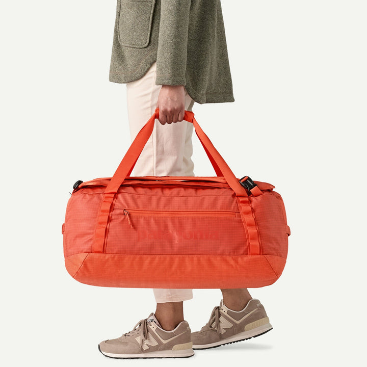 Patagonia Black Hole Duffel 55L - 100% postconsumer recycled polyester Pollinator Orange Bags